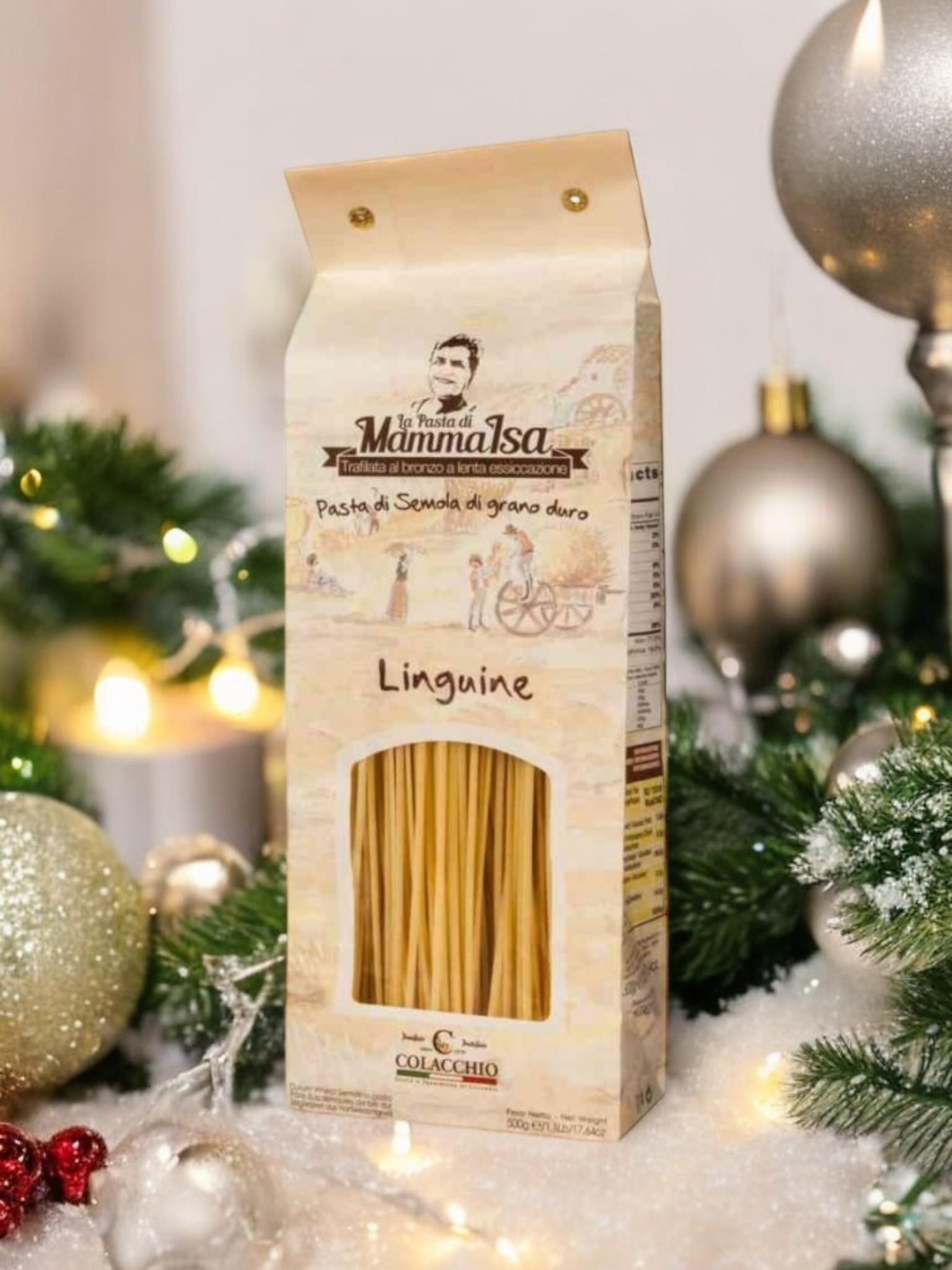 Ein Paket Linguine-Pasta (500g) von MammaSicura, aus Hartweizengrieß hergestellt, dekorativ vor weihnachtlicher Kulisse mit Christbaumkugeln und Tannenzweigen präsentiert.